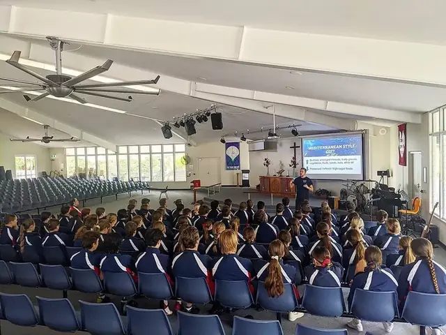 A sixth form cohort in a school hall