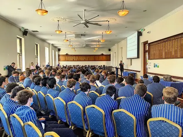 Students in blazers at a Simple Six presentation